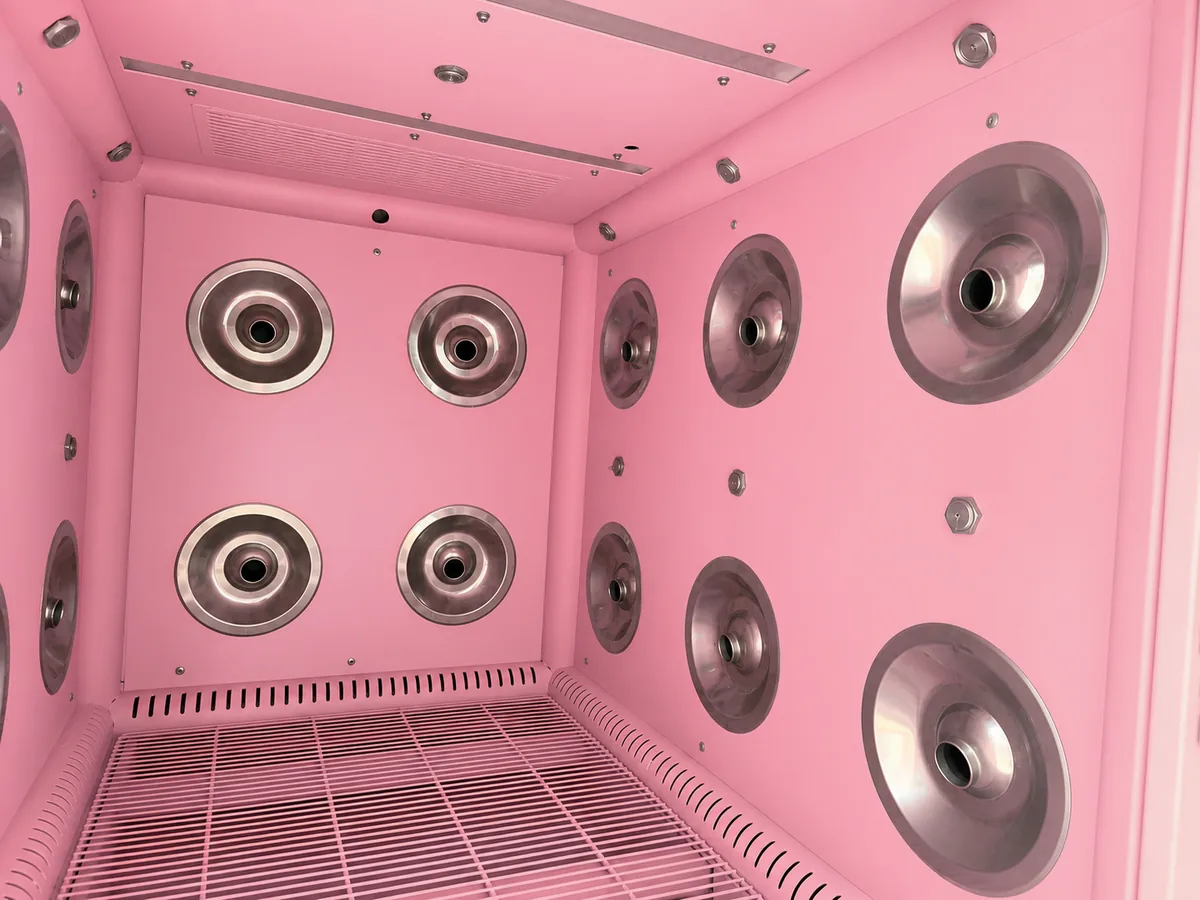 inside the pet wash machine cabin, stainless spray heads and drying outlets on every wall
